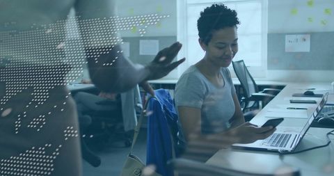 Digital world map overlay in office workspace