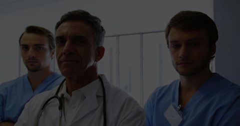 Senior Physician and Team in Modern Clinic Corridor