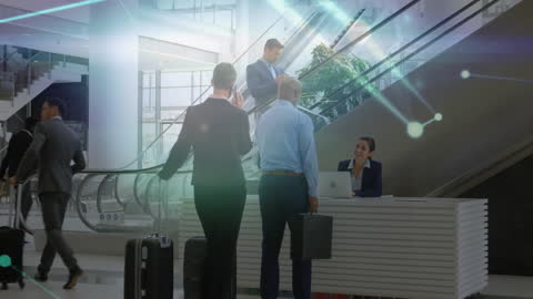 Multiple business executives are engaging in conversation at an office reception area, with a digital animation overlay representing data connections and global communication. The scene signifies an intersection of business and technology, illustrating themes of innovation, communication, and collaboration. Perfect for use in corporate presentations, business publications, technology solutions advertising, and expanded discussions on data-driven enterprises. The display of luggage highlights frequent business travel, adding an element of global reach.