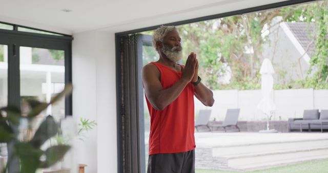 Image of african american senior man meditating. retirement lifestyle, spending time alone at home concept digitally generated image.