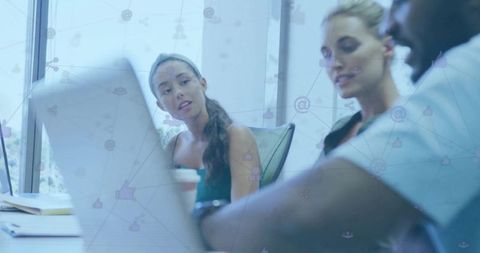 Modern Professionals Collaborating in Technology-Driven Meeting