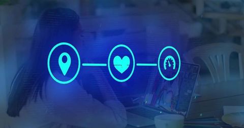 Coworking colleagues collaborating over laptop in cafe workspace with digital health icons