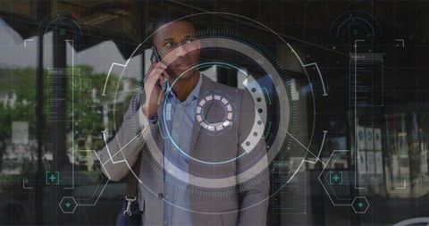 Businessman making phone call with futuristic hud overlay at urban glass entrance