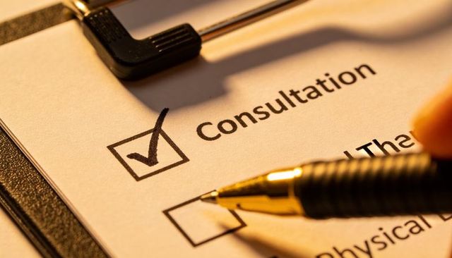 Completing consultation intake form closeup with gold pen checking box on clipboard
