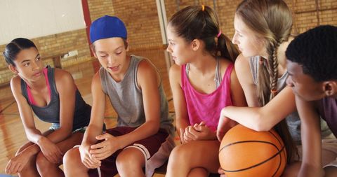 High School Students Conversing on Indoor Basketball Court Bench - Download Free Stock Images Pikwizard.com