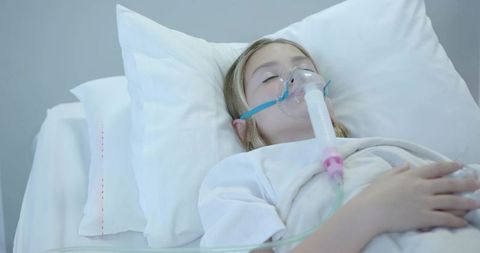 Young girl receiving oxygen therapy in hospital bed for pediatric respiratory recovery