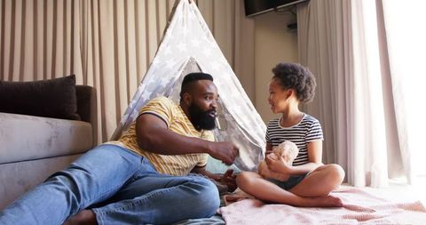 Father and Daughter Bonding in Stylish Living Room with Cozy Play Tent