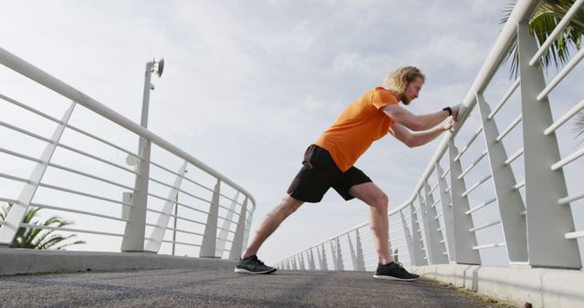 Athletic Man Stretching on Urban Bridge in Morning Light - Download Free Stock Images Pikwizard.com