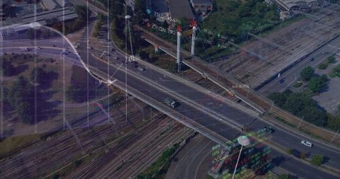 Aerial highway interchange with digital overlay visualizations, overpass, railyard, traffic