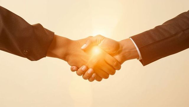 Sealing business partnership with firm handshake and warm light conveying trust