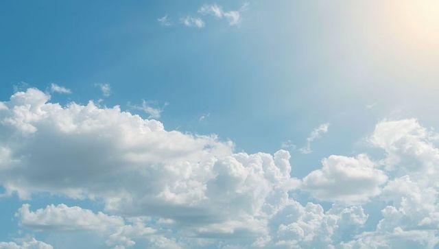 Serenity in the sky with puffy cumulus clouds and gentle sunlight