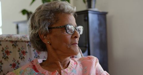 Elderly Woman Relaxing Thoughtfully by the Window
