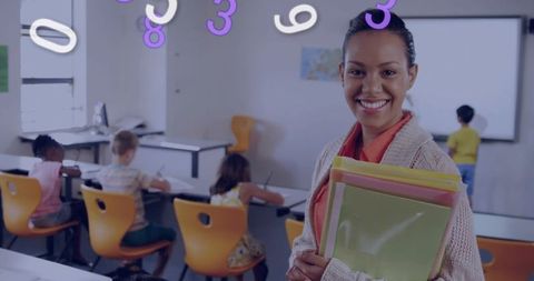 Smiling teacher holding pastel folders in bright classroom with orange chairs and students
