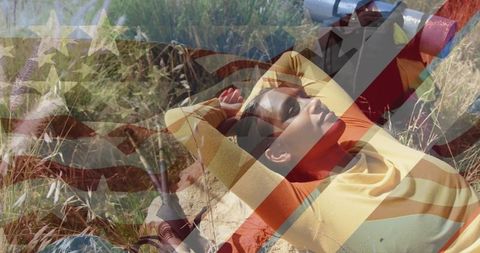 Biracial Woman Relaxing in Nature with Overlay of American Flag