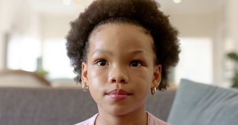 Serene Child Relaxing on a Cozy Sofa in Bright Living Room
