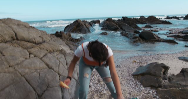 Person Enjoying Outdoor Picnic by Rocky Seaside with Sparse Waves - Download Free Stock Images Pikwizard.com