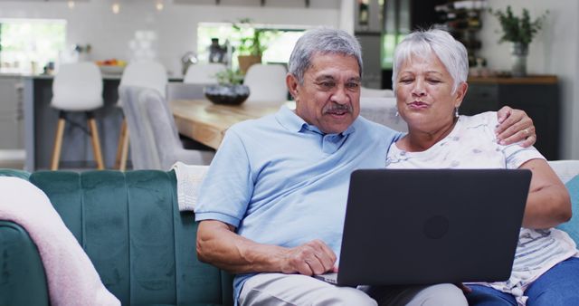 Happy senior biracial couple laughing and using tablet - Download Free Stock Photos Pikwizard.com