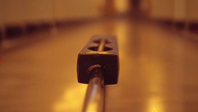 Sliding oil dispensing head on bowling lane for maintenance