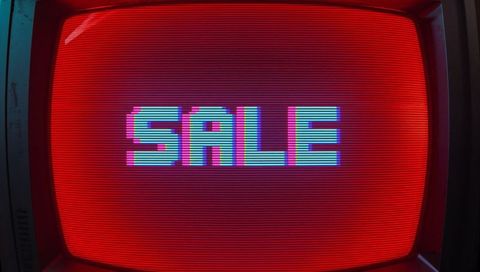 Retro crt monitor displaying pixelated sale text with neon glitch and red scanlines