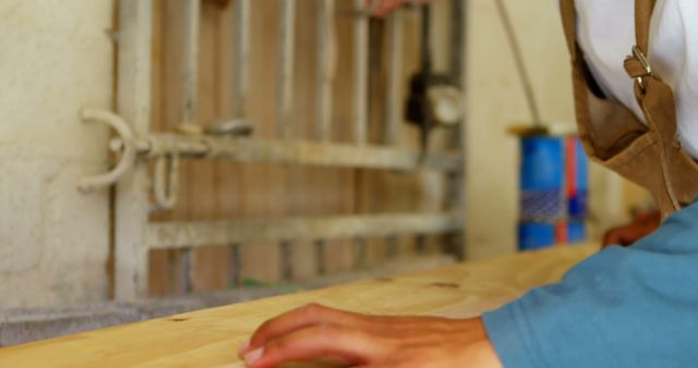 Carpenter Focusing on Smoothing Wooden Plank with Precision - Download Free Stock Images Pikwizard.com