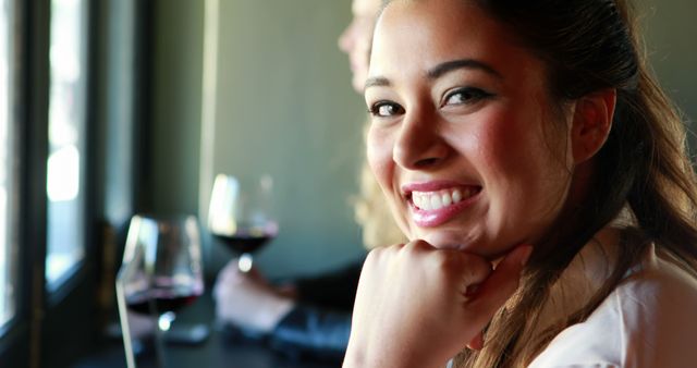 Young Woman Smiling and Drinking Red Wine at Restaurant - Download Free Stock Images Pikwizard.com