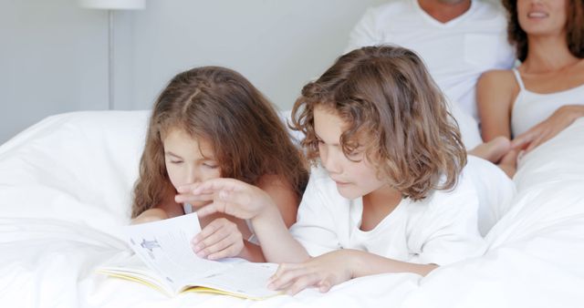 Children Reading Storybook in Bed with Parents Nearby - Download Free Stock Images Pikwizard.com