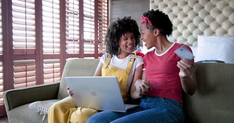 Happy Couple Shopping Online with Laptop and Credit Card