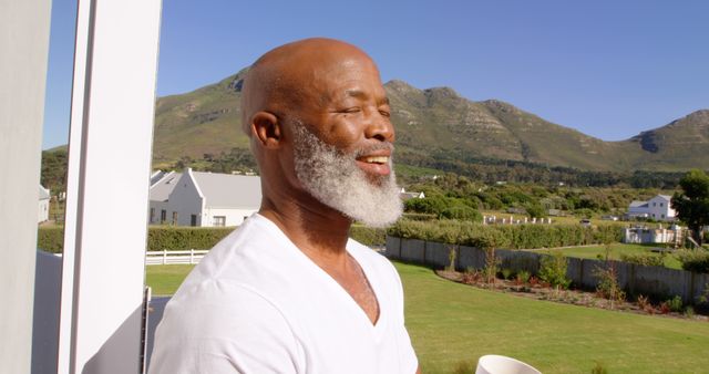 Senior Man Enjoying Sunny Day on Balcony with Scenic Mountain View - Download Free Stock Images Pikwizard.com