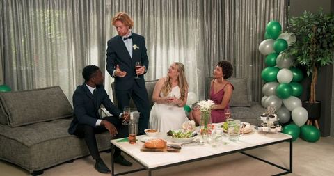 Joyful wedding reception toast in modern living room