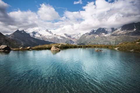 Cover background pristine mountain lake with snow-capped peaks