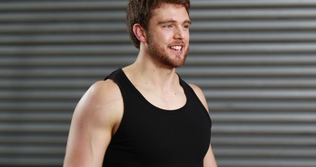Smiling Fit Young Man in Black Tank Top at Gym - Download Free Stock Images Pikwizard.com
