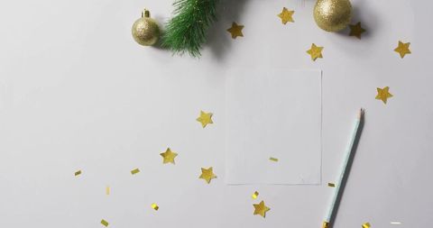 Festive blank card mockup with gold confetti, glitter stars, mint pencil and fir branch flatlay