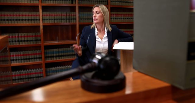 A Caucasian middle-aged female lawyer presents her case in a courtroom, with copy space - Download Free Stock Photos Pikwizard.com