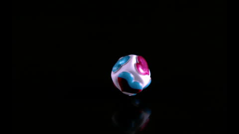 Colorful Heart Dice Bouncing Smoothly in Darkness