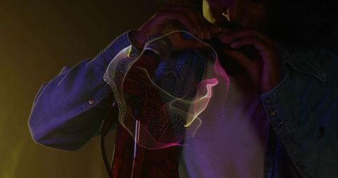 Enigmatic Harmonica Performance with Dynamic Light Effects