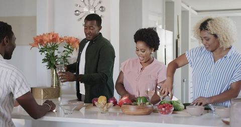 Cheerful Friends Cooking Together in Modern Kitchen