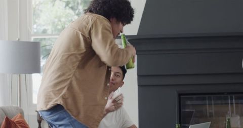 Friends Laughing and Celebrating with Drinks at Home