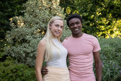 Diverse Couple Enjoying Summer Vibes in Lush Garden Setting