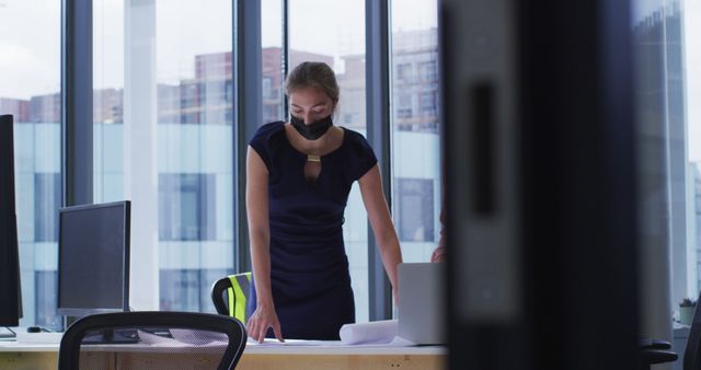 Businesswoman Wearing Mask Working in Modern Office - Download Free Stock Images Pikwizard.com