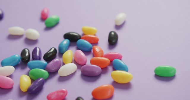 Colorful Jelly Beans Scattered on Purple Background - Download Free Stock Images Pikwizard.com