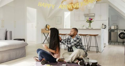 Couple Celebrating Romantic Anniversary at Home with Gift Exchange