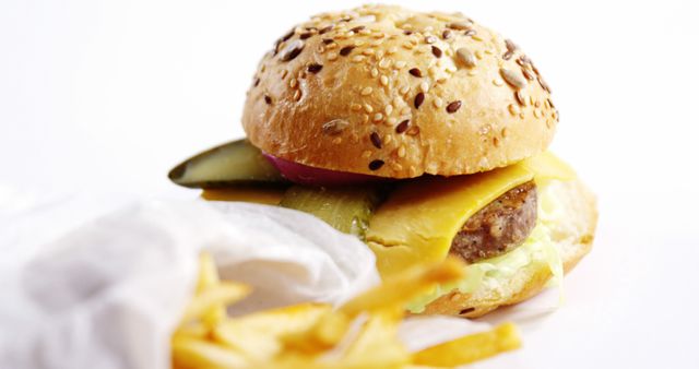 Close-Up of a Delicious Cheeseburger with Fries on White Background - Download Free Stock Images Pikwizard.com