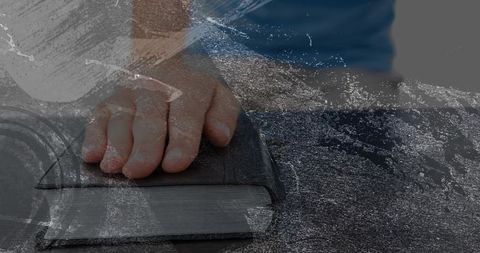 Resting child hand pressing closed book on desk with ocean wave double exposure