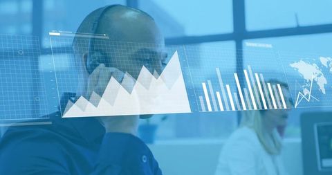 Customer support analyst wearing headset reviewing live data dashboards and analytics