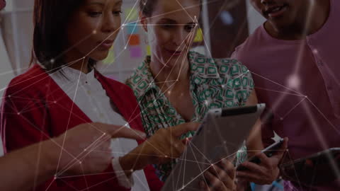 Diverse Team Engaging with Digital Tablet in Modern Office