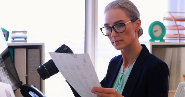 Senior Woman Photographer Reviewing Film Negatives in Office - Download Free Stock Images Pikwizard.com