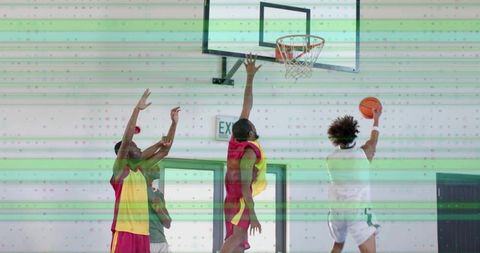 Athlete Shooting Basketball Layup in Gym