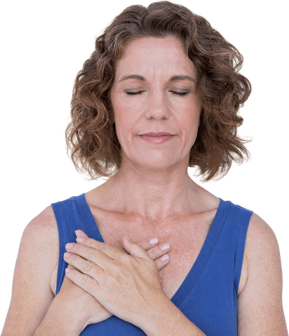 Peaceful Mature Woman Meditating with Eyes Closed and Hands on Chest