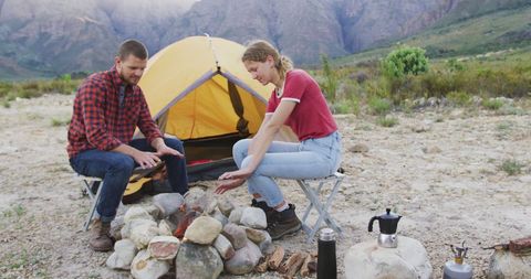 Couple Enjoying Mountain Camping by the Fire