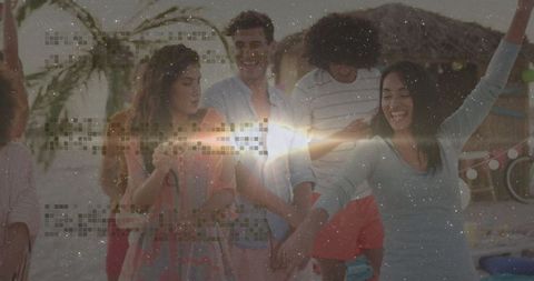 Friends Celebrating on Sandy Beach at Sunset